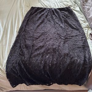 Black skirt with interior black liner ends above knee, skirt full length. NWOT